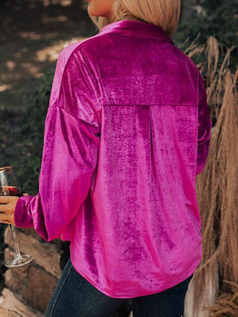 a woman in a pink shirt holding a wine glass