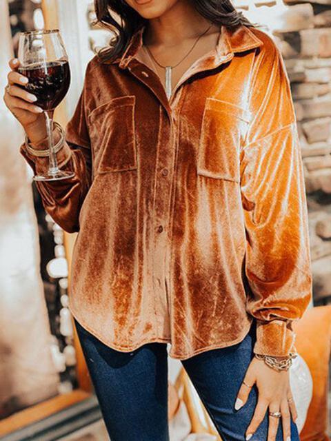 a woman is holding a glass of wine