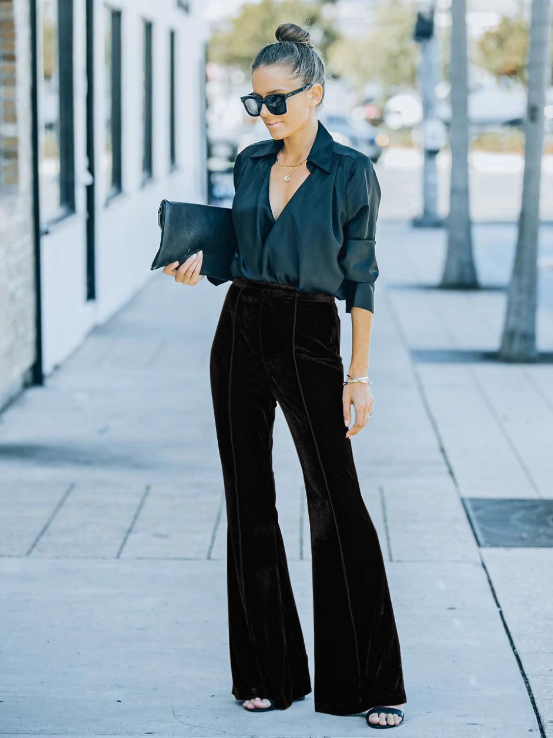 a woman wearing black pants and a black blouse