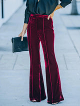 a woman in a black shirt and red pants