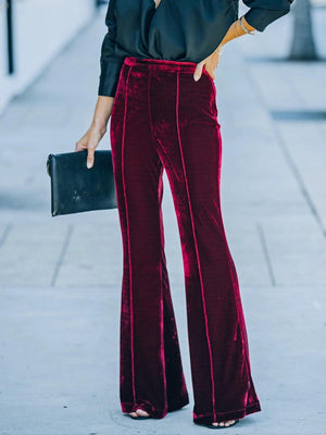 a woman in a black shirt and red pants