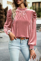 a woman wearing a pink top and jeans