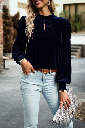 a woman wearing a black top and jeans