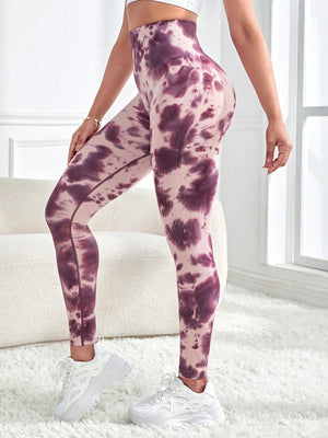 a woman in a white top and purple tie dye leggings