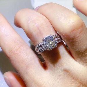 a close up of a person's hand holding a ring