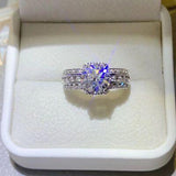 a diamond ring in a white box on a table