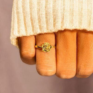 a woman's hand with a gold ring on it