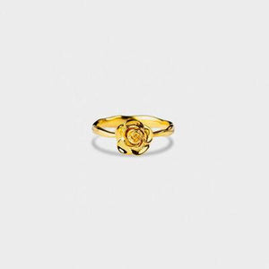 a gold ring with a rose on it