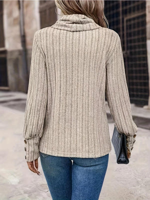 a woman walking down a street wearing a sweater