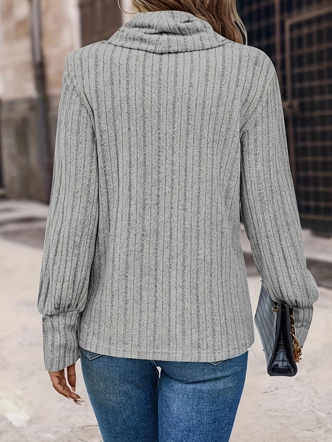 a woman walking down a street wearing a gray sweater