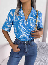 a woman wearing a blue shirt and jeans