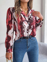 a woman wearing a red and white shirt and jeans