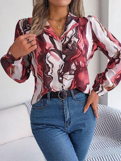 a woman in jeans and a blouse posing for a picture