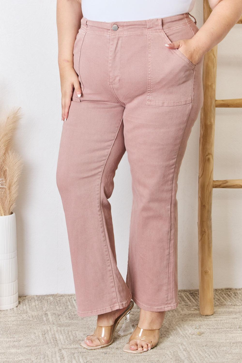 a woman in a white top and pink pants