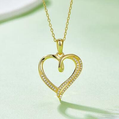 a diamond heart pendant on a gold chain