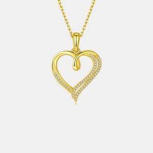 a gold heart pendant with diamonds on a chain