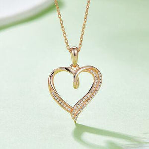 a diamond heart pendant on a gold chain