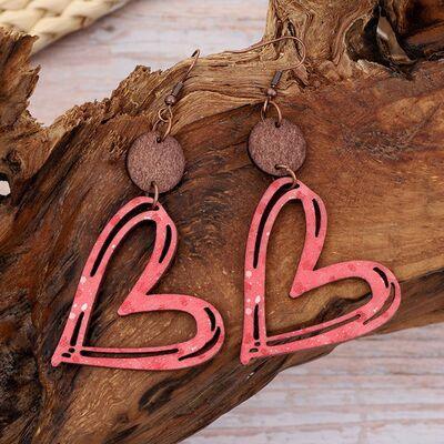 a pair of pink and brown heart shaped earrings