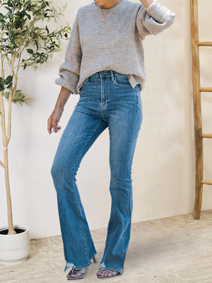 a woman in a gray sweater and blue jeans