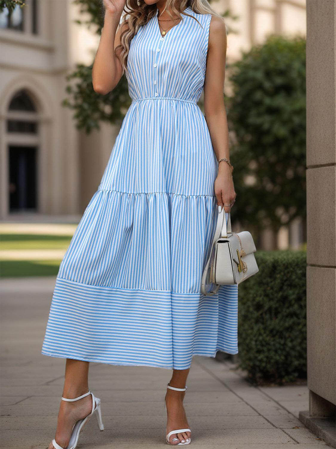 a woman in a blue dress is talking on a cell phone