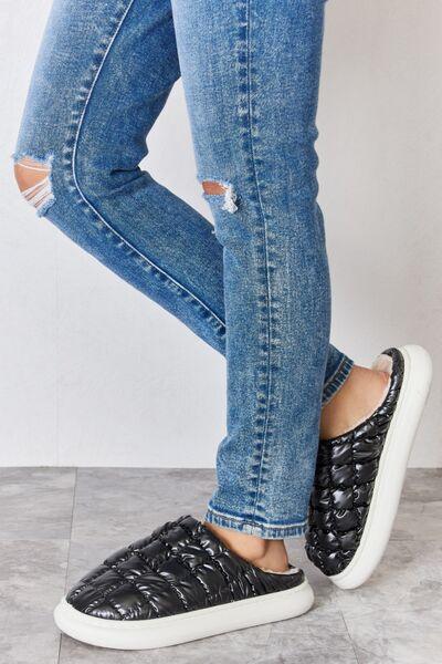 a person standing on top of a pair of jeans
