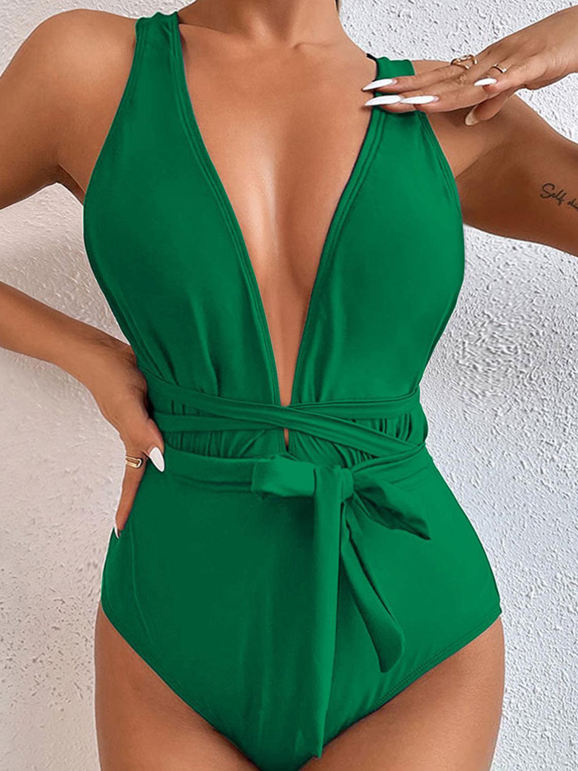 a woman in a green one piece swimsuit