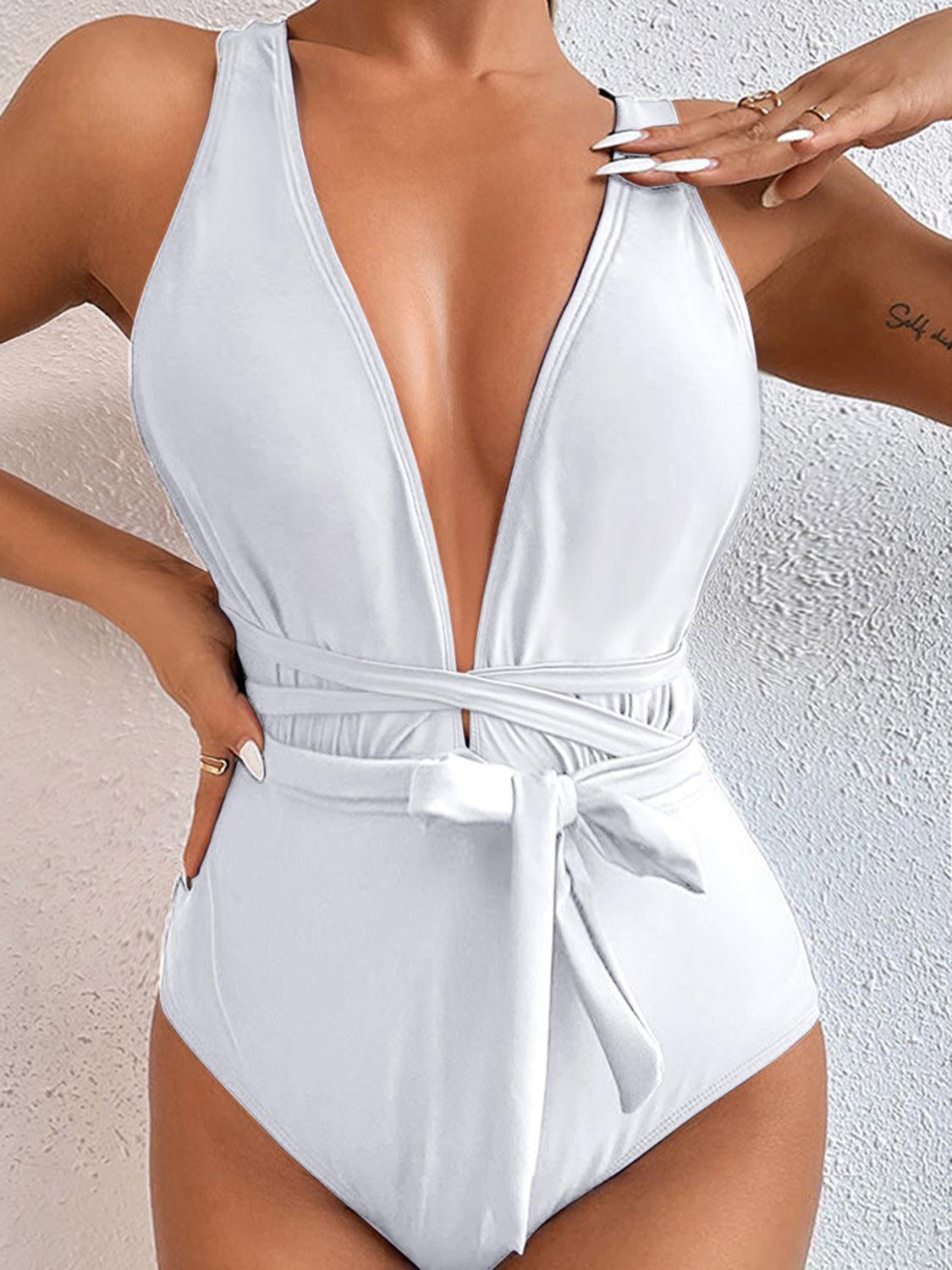 a woman in a white one piece swimsuit