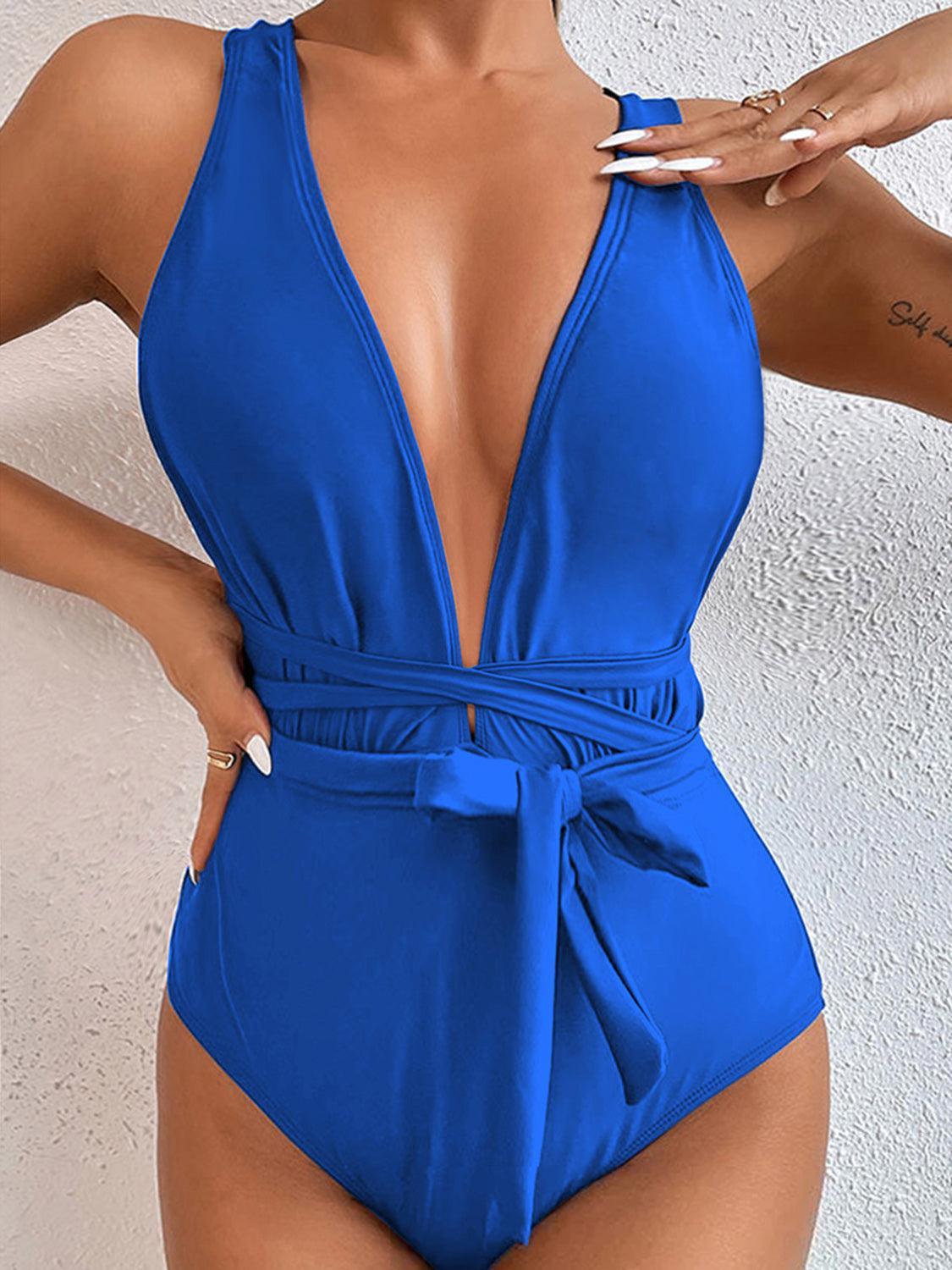 a woman in a blue one piece swimsuit