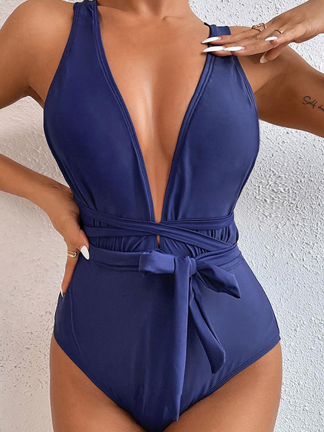 a woman in a blue one piece swimsuit