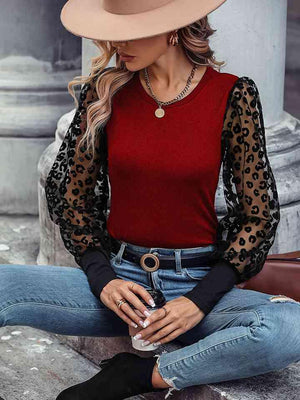 a woman wearing a red top and jeans