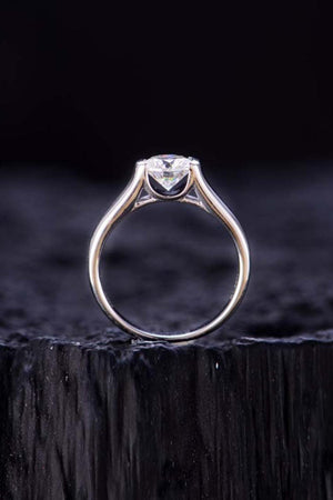a close up of a diamond ring on a piece of wood