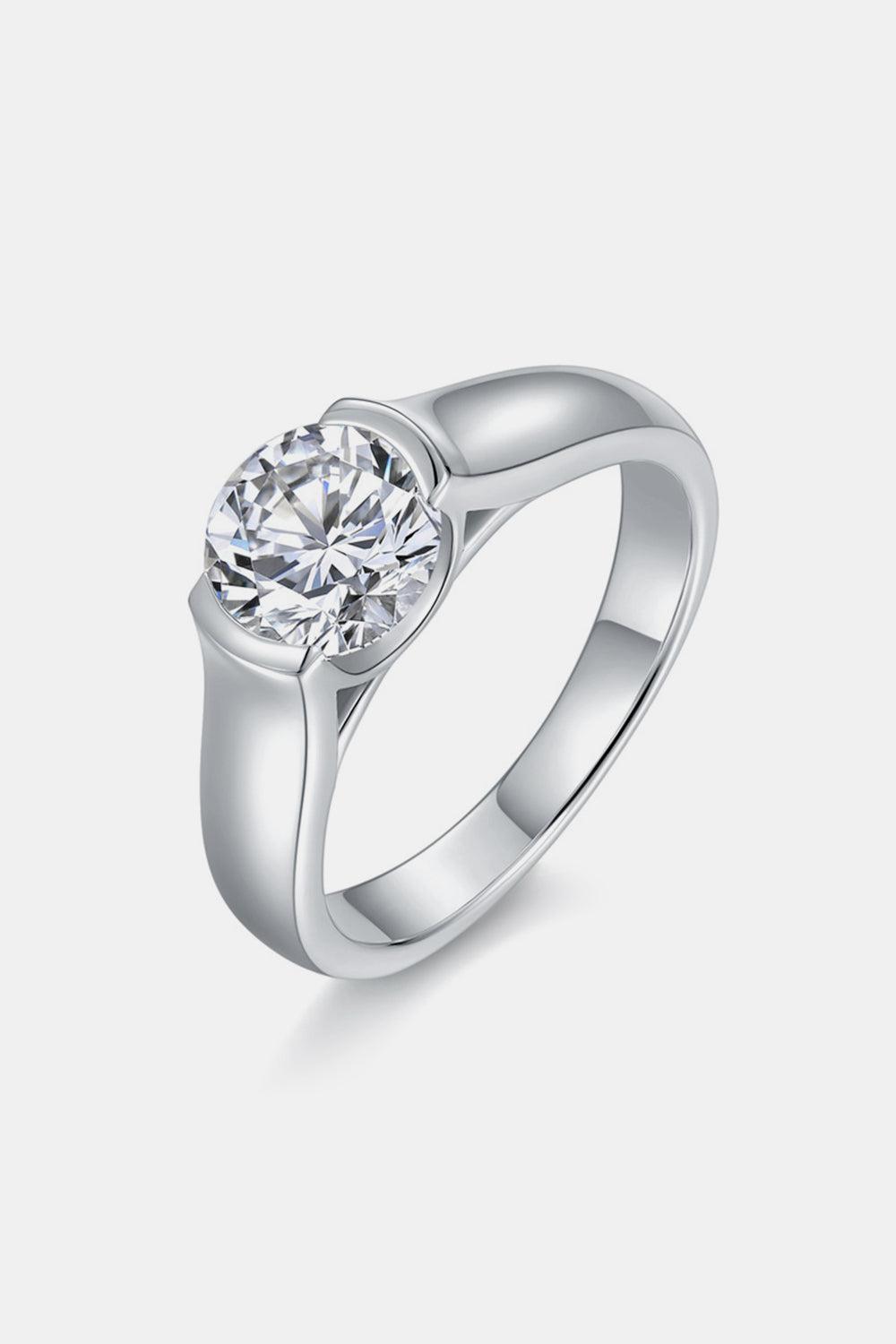 a white gold ring with a round diamond