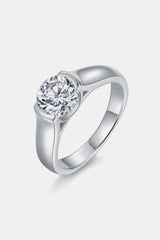 a white gold ring with a round diamond