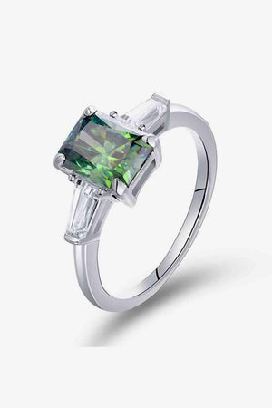 a white gold ring with a green diamond