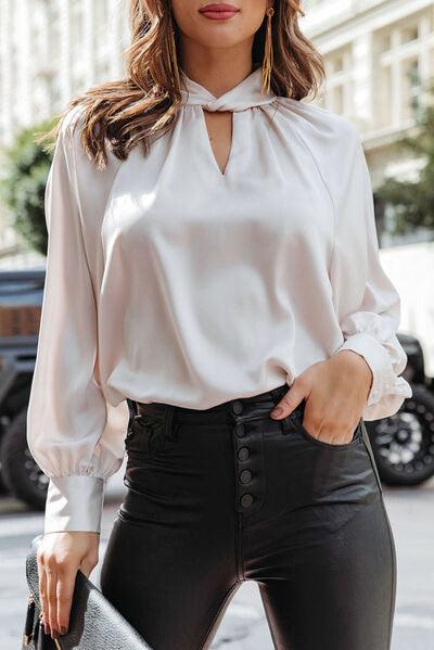 a woman wearing a white blouse and black pants