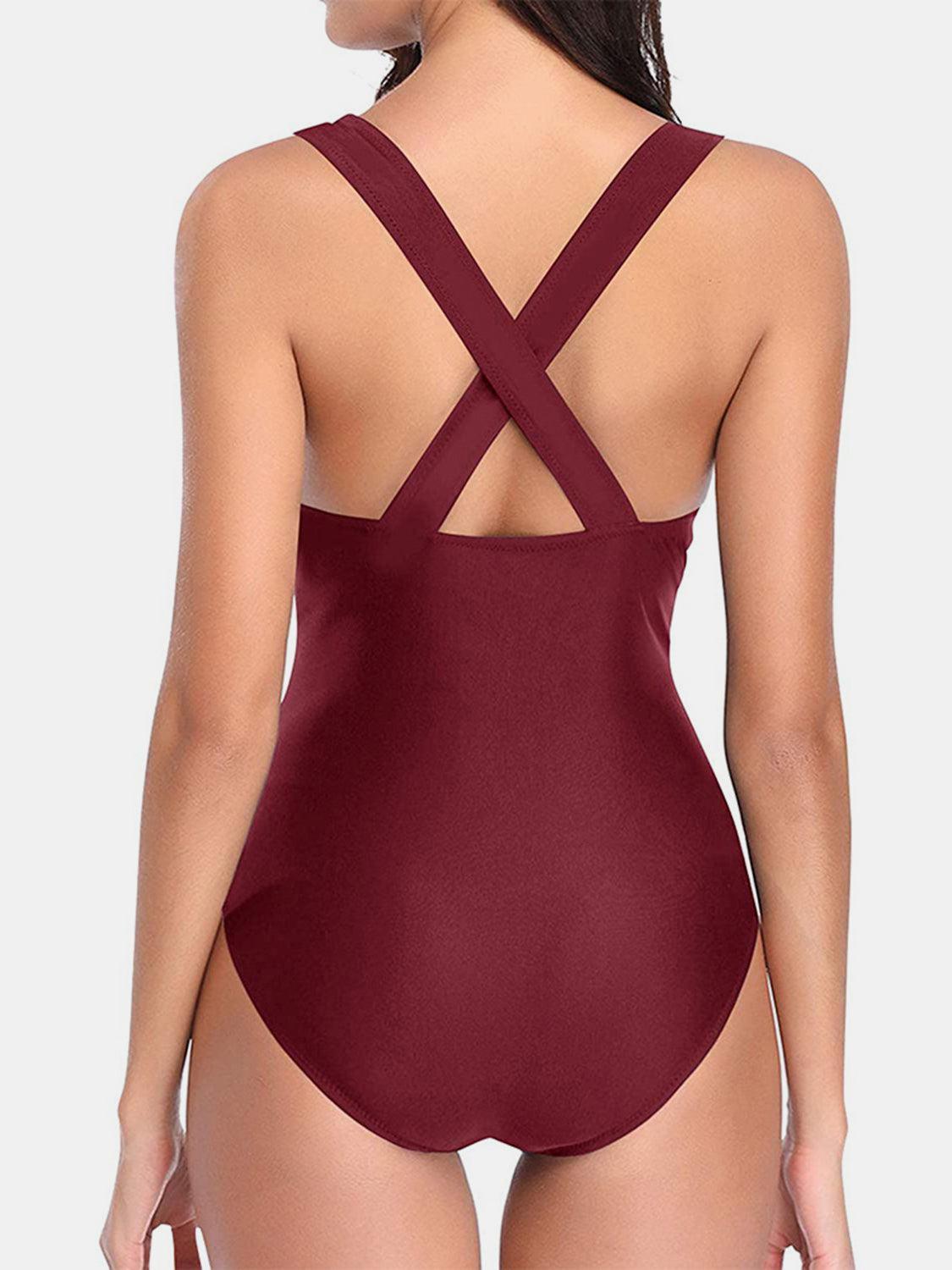 a woman in a maroon one piece swimsuit