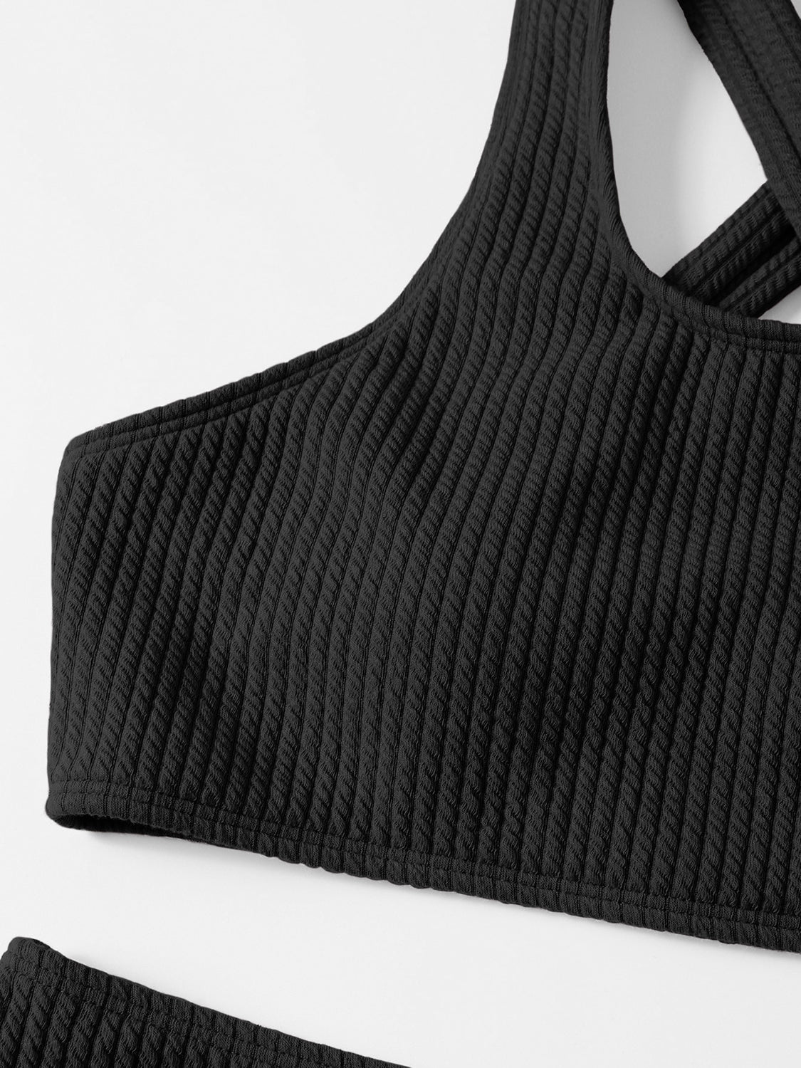 a black top with a halt neck and straps