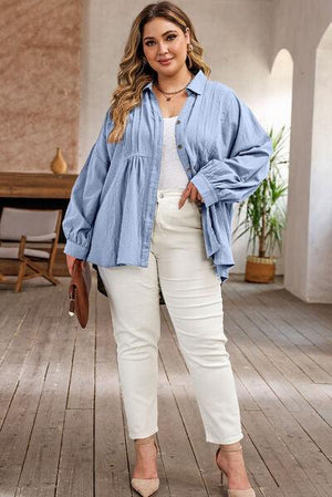 a woman standing on a wooden floor wearing a blue shirt and white pants