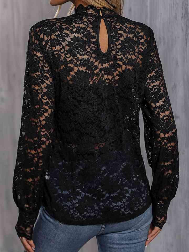 a woman wearing a black lace top