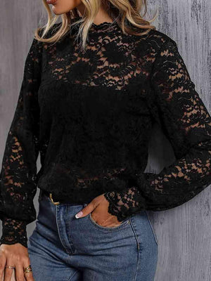 a woman wearing a black lace top