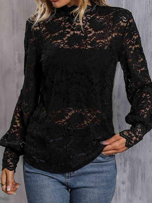 a woman wearing a black lace top