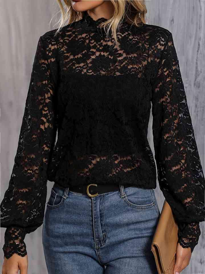 a woman wearing a black blouse and jeans