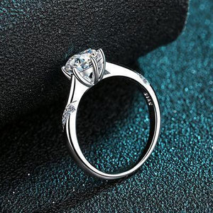 a close up of a diamond ring on a black surface