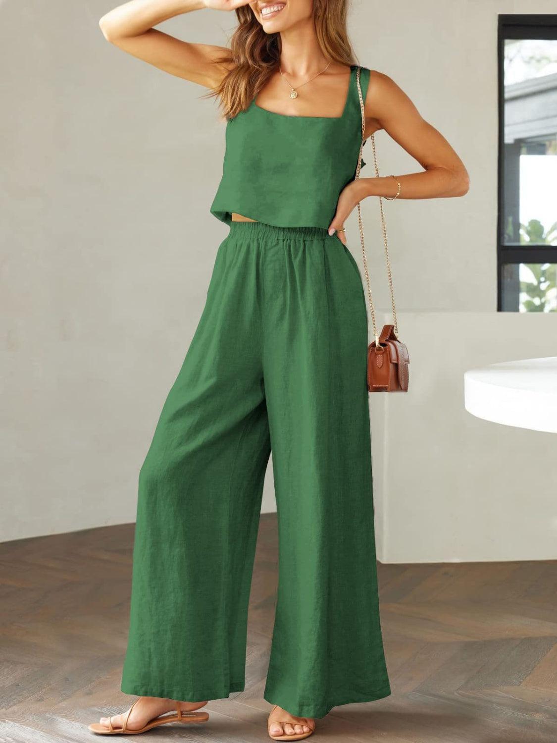 a woman in a green jumpsuit posing for the camera