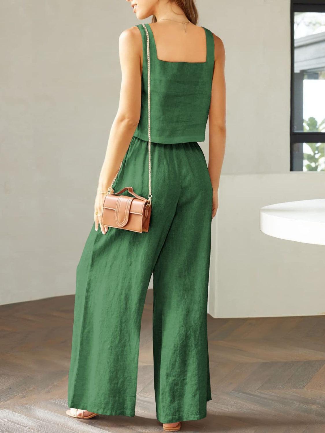 a woman in a green jumpsuit with a handbag