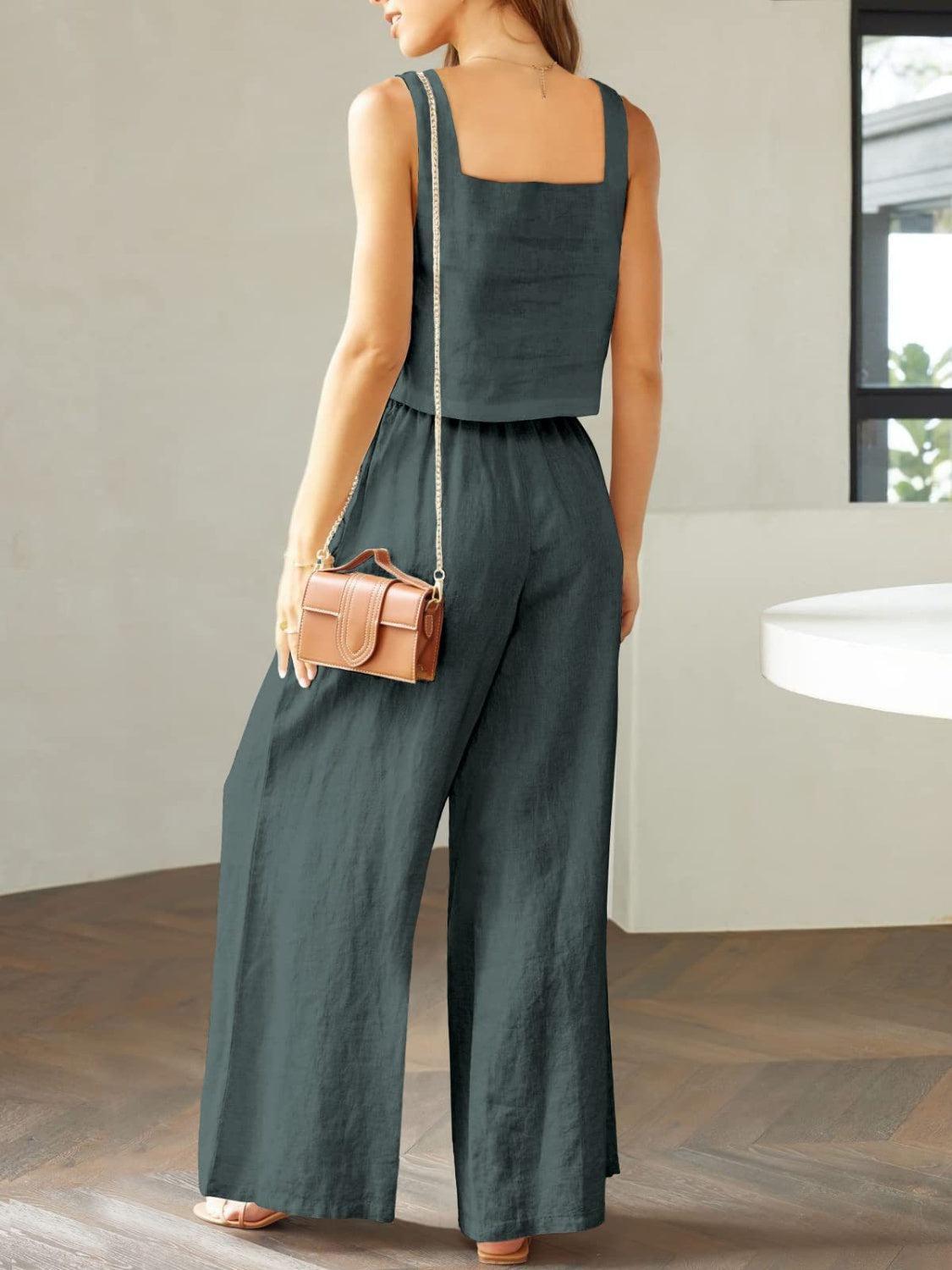 a woman in a green jumpsuit holding a purse