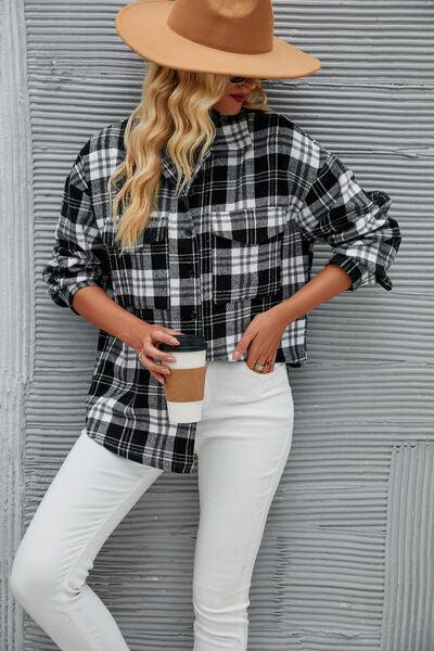 a woman wearing white jeans and a plaid shirt