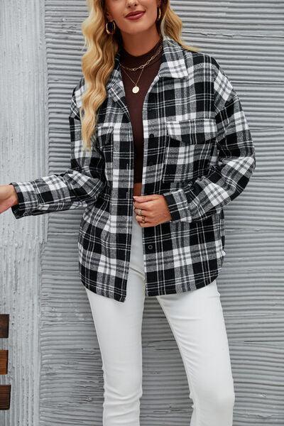 a woman wearing a black and white plaid jacket