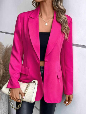 a woman wearing a pink blazer and black pants