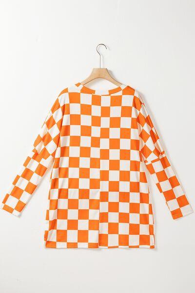 an orange and white checkered shirt hanging on a hanger